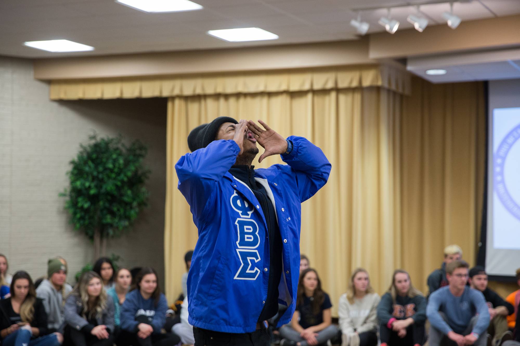 student chanting with their hands around their mouth